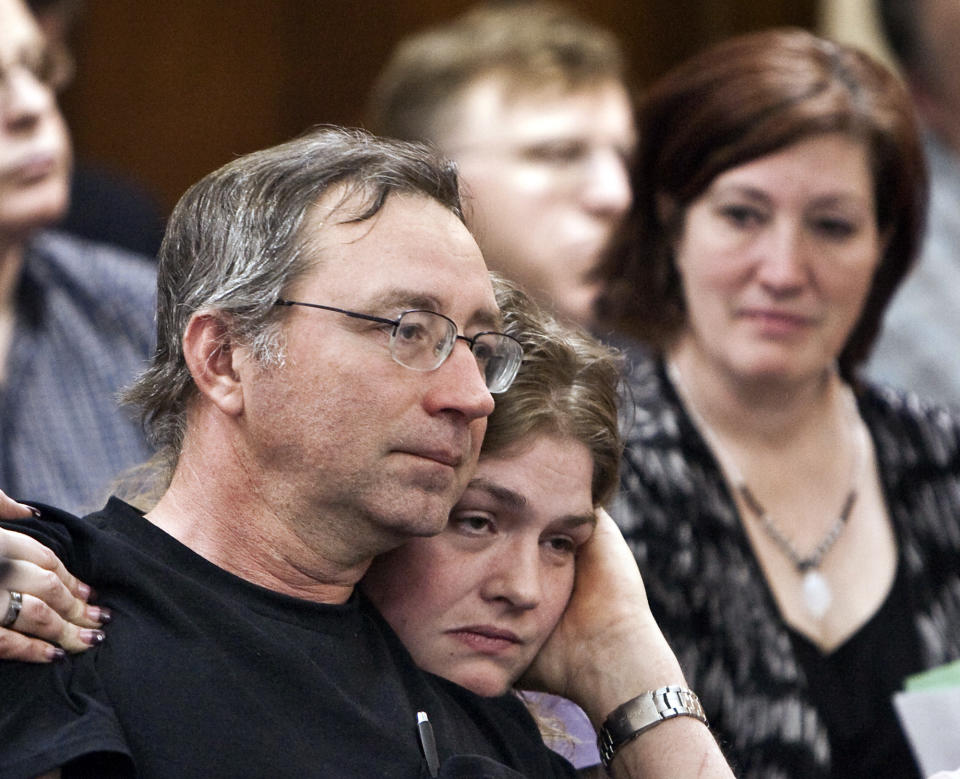 FILE - In this Thursday, Feb. 19, 2009, file photo, Joseph White, left, one of six people wrongly convicted of the rape and murder of Helen Wilson in 1985, is hugged by Rachel Morgan, daughter of Ada Joann Taylor, another member of the "Beatrice Six," right, following his testimony before the Judiciary Committee in Lincoln, Neb. A Nebraska county that owes more than $30 million to six people wrongfully convicted of murder has approved a new half-cent sales tax to help pay the legal judgment, but the former prisoners will still have to wait at least six years to collect the full amount they’re owed. (AP Photo/Nati Harnik, File)