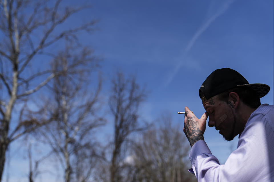 Joshua Messer, 29, sits on the front stoop of his aunt's house where he is currently staying days after overdosing Tuesday, March 16, 2021, in Huntington, W.Va. Messer was a high school basketball star, heading to college on a scholarship. He still brags that he was such a star athlete he once met the governor. But addiction took hold, to alcohol and pills. "I let my family down, now I'm trying to get it back together. I look at some people and it's sad how they look," he said. "I'm starting to look like that. I'm not better than other people. But I'm better than letting something take control of my life. I feel like I should be better than this." (AP Photo/David Goldman)