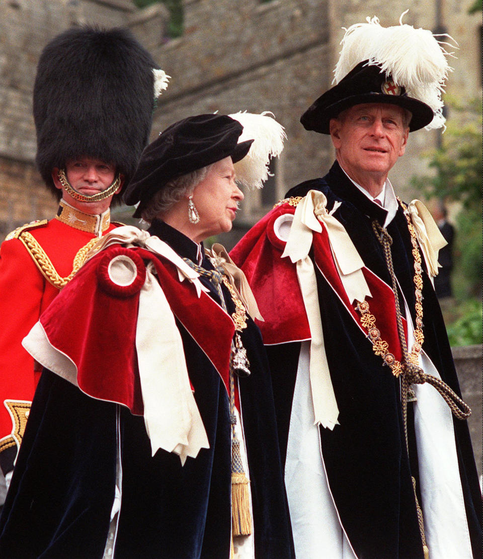 FILE - In this June 15, 1998 file photo, Britain's Queen Elizabeth II and her husband Prince Philip, right, lead the annual procession of members of the Order of the Garter from Windsor Castle to St. George's Chapel in Windsor, England. Buckingham Palace says Prince Philip, husband of Queen Elizabeth II, has died aged 99. (AP Photo/Alastair Grant, File)
