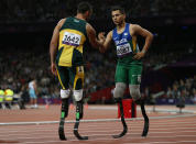 Brazil's Alan Oliveira (R) is congratulated by South Africa's Oscar Pistorius after winning the men's 200m T44 classification at the Olympic Stadium during the London 2012 Paralympic Games September 2, 2012. This classification is for athletes with an impairment that affects their arms or legs, including amputees. REUTERS/Eddie Keogh (BRITAIN - Tags: SPORT ATHLETICS OLYMPICS) - RTR37F1Y