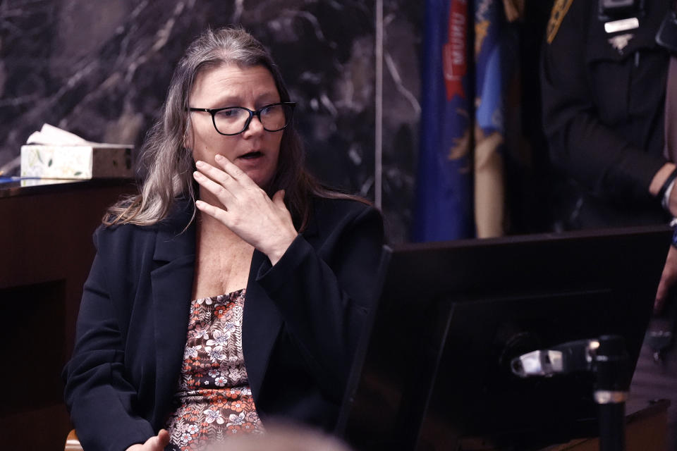 Jennifer Crumbley looks at a monitor as she testifies during her trial in the Oakland County courtroom Friday, Feb. 2, 2024, in Pontiac, Mich. Crumbley, 45, is charged with involuntary manslaughter. Prosecutors say she and her husband were grossly negligent and could have prevented the four deaths if they had tended to their son’s mental health. They’re also accused of making a gun accessible at home. (AP Photo/Carlos Osorio, Pool)