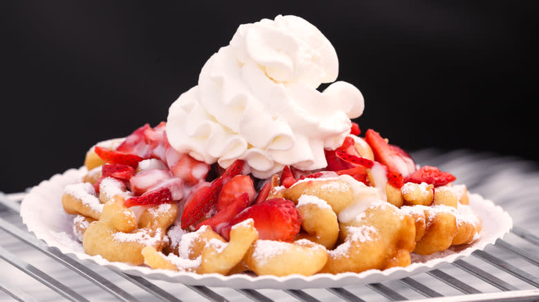 funnel cake with strawberries and whipped cream