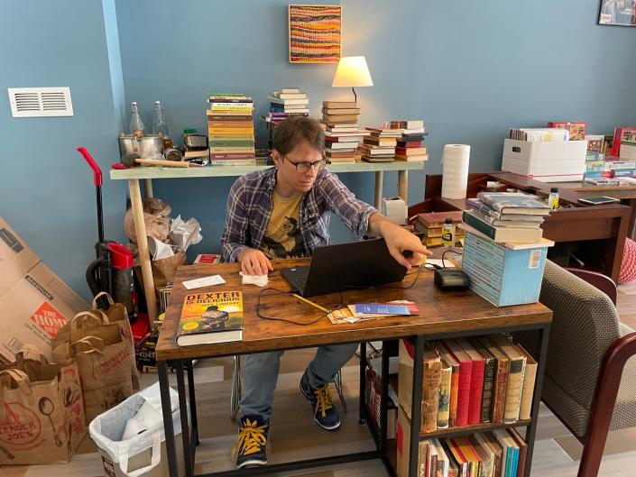 Bryce McQuern, owner/operator of lowercase books in Parkridge, researches some titles. He says his favorite thing to do is clean and price the books. July 13, 2022