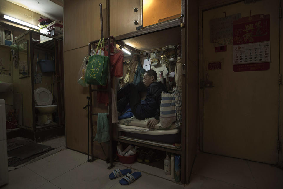 <p>Wong Tat-ming, 63, sits in his “coffin home” In Hong Kong. (Photo: Kin Cheung/AP) </p>