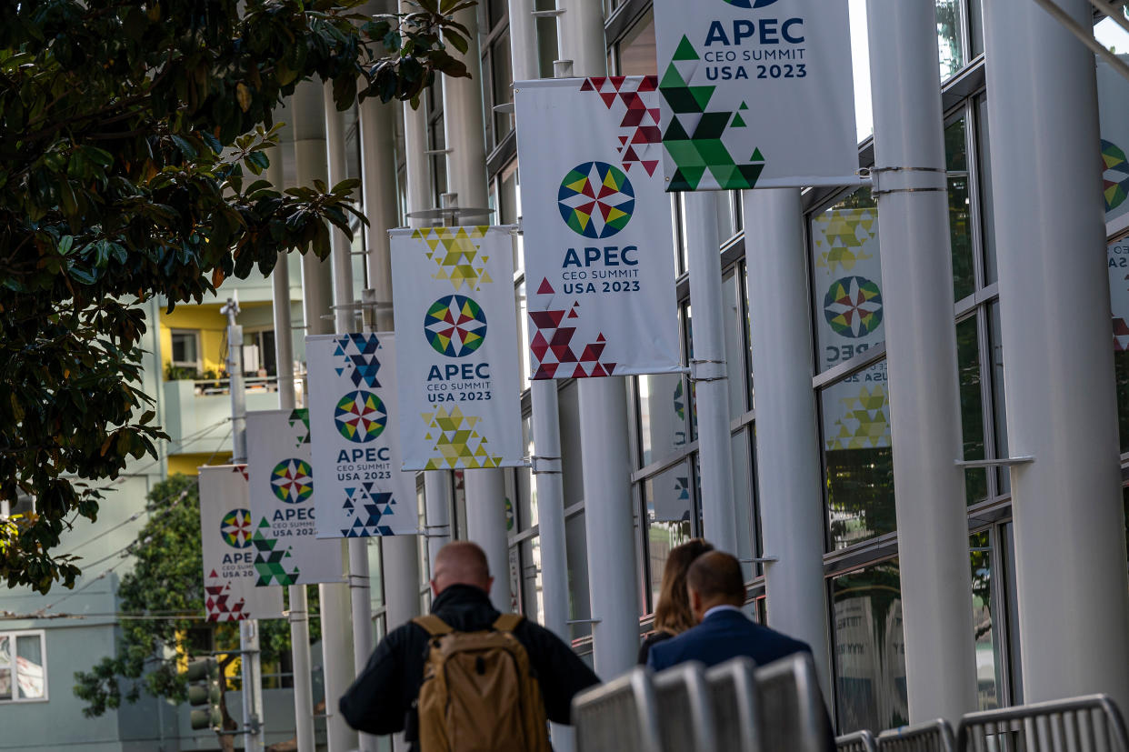 People walk past the Moscone West Convention Center ahead of the APEC summit.