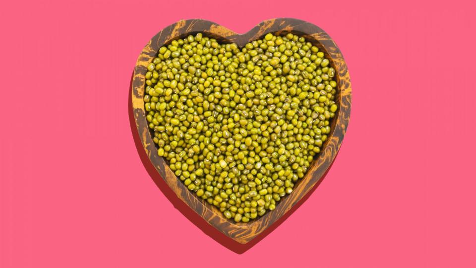 Directly Above Shot Of Mung Beans In Heart Shape Bowl Over White Background