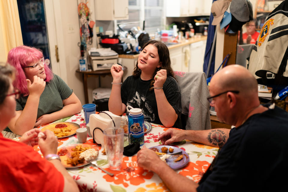 Maddie, 15, right center, eats dinner with her family in North Carolina. “My family is my whole life,” Maddie says. Whenever they have to make a decision, she says, they always consider how it will impact all four of them. “I love that for us,” she says. “All the times I’m with my family, whether we’re fighting or whether we’re laughing, it’s always good times.”<span class="copyright">Annie Flanagan</span>