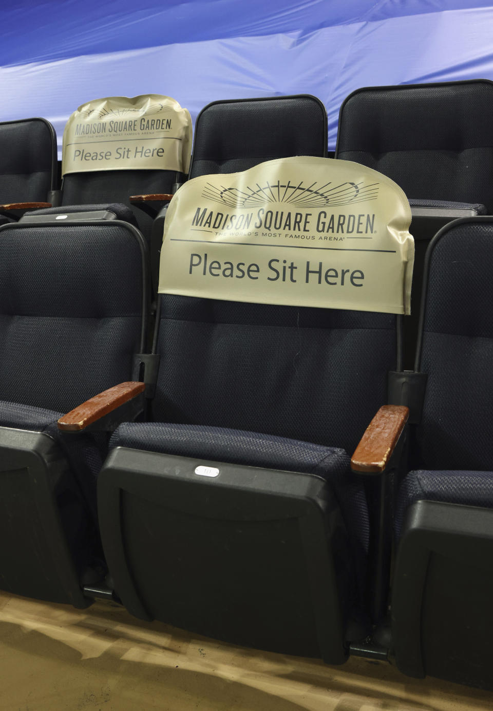 Seats are earmarked for fans at future games prior to the NHL hockey game between the New York Rangers and the Boston Bruins at Madison Square Garden Wednesday, Feb. 10, 2021, in New York. New York State announced today that arenas can re-open on Feb. 23 at 10% occupancy. (Bruce Bennett/Pool Photo via AP)