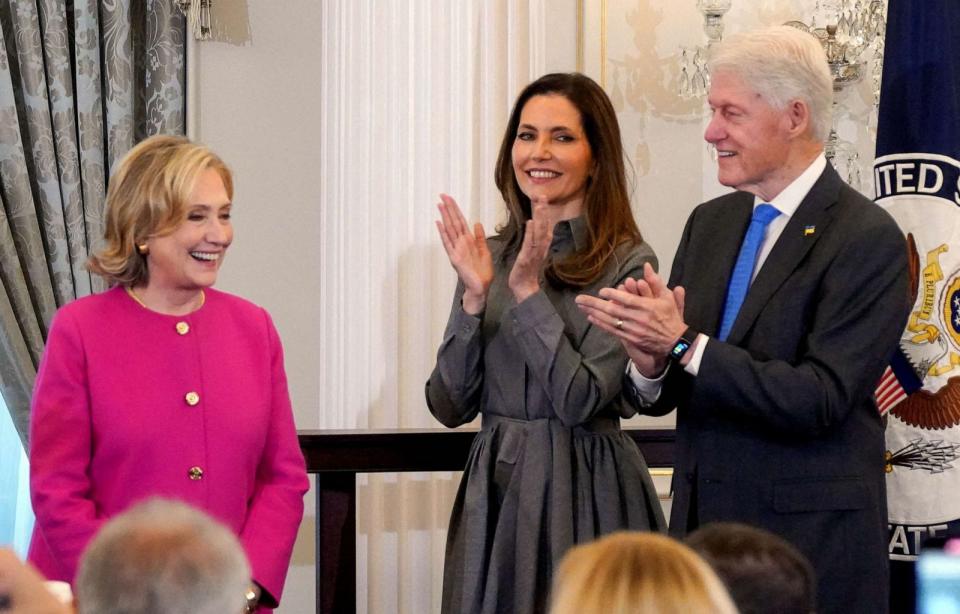 PHOTO: Secretary of State Antony Blinken's wife Evan Ryan and former U.S. President Bill Clinton congratulate former U.S. Secretary of State Hillary Rodham Clinton during the unveiling of her portrait, at the State Department in Washington, Sept. 26, 2023 (Ken Cedeno/Reuters)