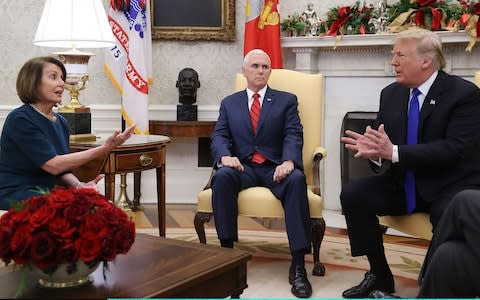 Donald Trump argues about border security with Nancy Pelosi as Vice President Mike Pence looks on - Credit: Mark Wilson/Getty