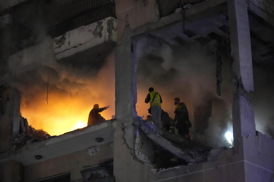 Civil defense workers search for survivors inside a destroyed apartment following a massive explosion in the southern suburb of Beirut, Lebanon, Tuesday, Jan. 2, 2024. The TV station of Lebanon's Hezbollah group says top Hamas official Saleh Arouri was killed Tuesday in an explosion in a southern Beirut suburb.(AP Photo/Hussein Malla)