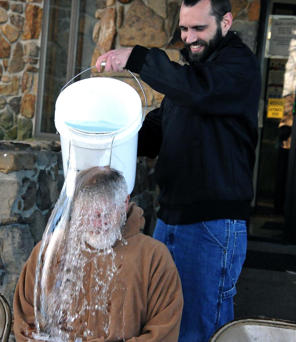 PRC-Saltillo CEO Dave Hershberger has a large bucket of ice-cold water poured on his head by Doug Jenkins. The company raised $8,300 for ALS through the challenge.