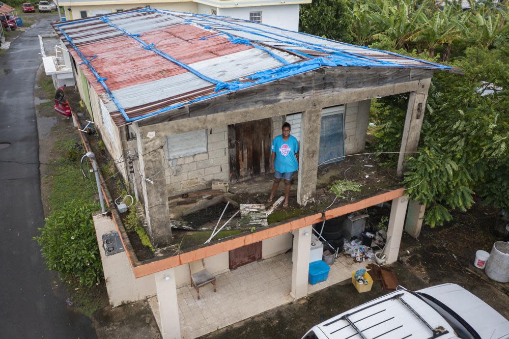 Jetsabel Osorio stands in her house damaged five years ago by Hurricane Maria before the arrival of Tropical Storm Fiona in Loiza, Puerto Rico, Saturday, Sept. 17, 2022. Fiona was expected to become a hurricane as it neared Puerto Rico on Saturday, threatening to dump up to 20 inches (51 centimeters) of rain as people braced for potential landslides, severe flooding and power outages. (AP Photo/Alejandro Granadillo)