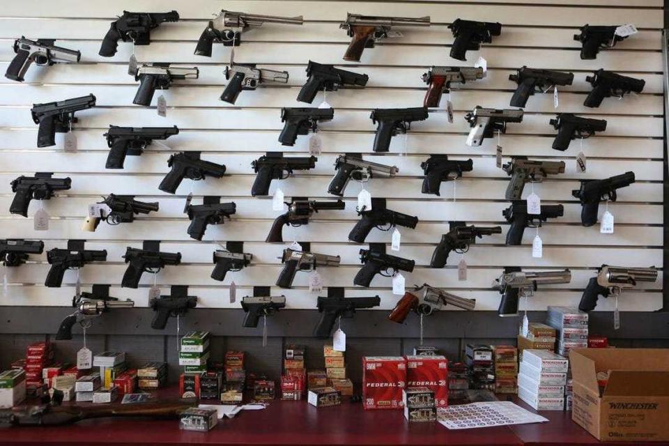Handguns are displayed at a gun store in Palm Springs in 2019. An Assembly bill would levy a state excise tax on gun and ammunition dealers, vendors and manufacturers.