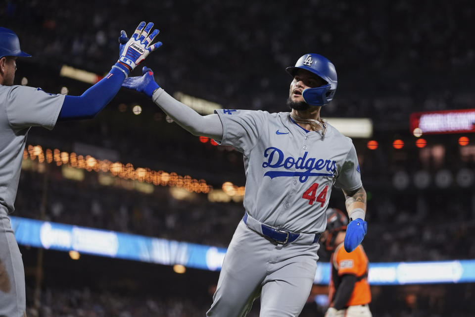 Los Angeles Dodgers' Andy Pages, right, celebrates with Miguel Rojas after scoring against the San Francisco Giants on Jason Heyward's sacrifice fly during the ninth inning of a baseball game Friday, June 28, 2024, in San Francisco. (AP Photo/Godofredo A. Vásquez)