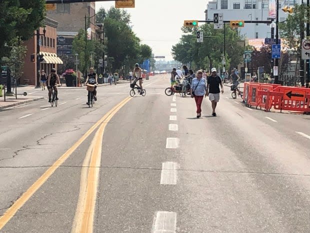 Calgarians stroll through Inglewood on the first Car Free Sunday on Aug. 1. The initiative will extend throughout the month of August. (Thomas Laberge/CBC - image credit)