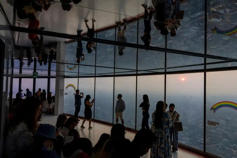 Tourists visiting Toronto's CN Tower capture smoke blanketing city