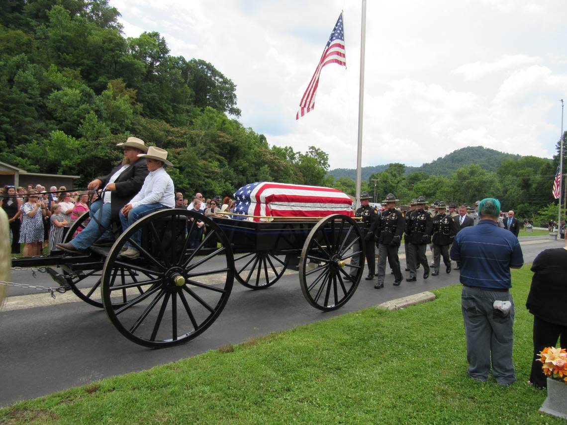 A horse-drawn carriage delivered the casket of slain Floyd County, Ky., sheriff’s Deputy William Petry to his burial place on July 5, 2022.