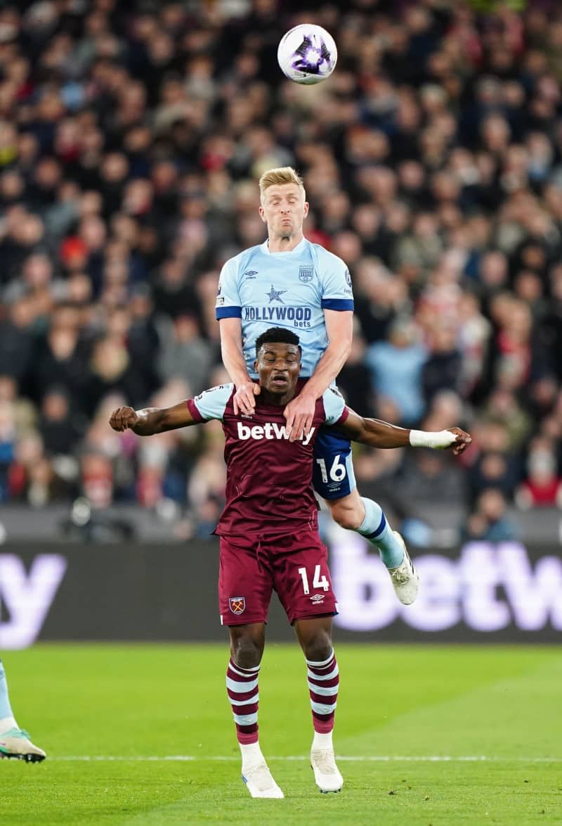 Brentford's Ben Mee (UP) and West Ham United's Mohammed Kudus battle for the ball during the English Premier League soccer match between West Ham United and Brentford at the London Stadium. Zac Goodwin/PA Wire/dpa