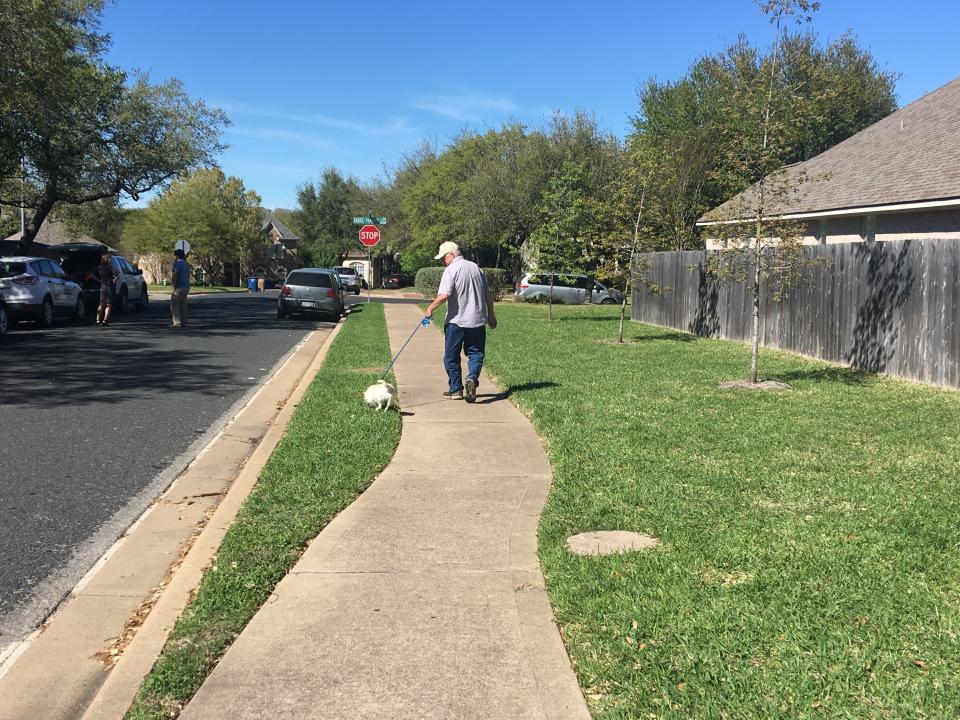 James Barnes walks his dog toward the spot where, days earlier, a tripwire bomb detonated in his sleepy neighborhood in Austin. (Photo: Andy Campbell/HuffPost)