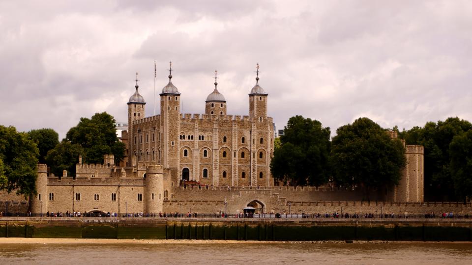 The beauty of historical workmanship of the Tower of London as seen across the river Thames in the United Kingdom