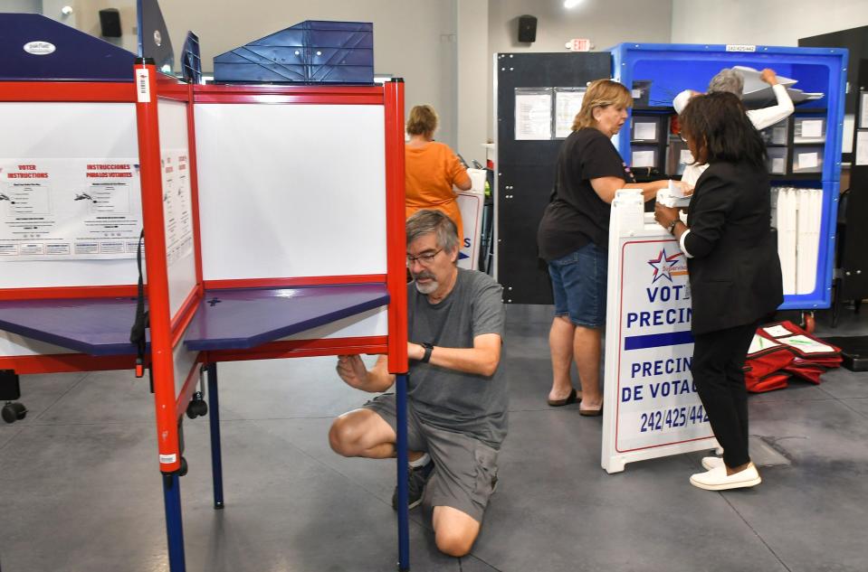 Poll workers set up voting equipment at Cross Bridge Church in Rockledge in advance of the Tuesday municipal election there.