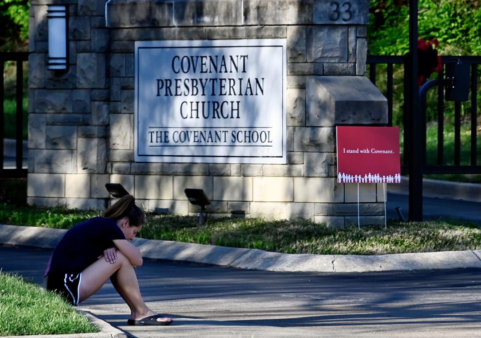 Megan Scheumann pauses to reflect at the entrance to the Covenant School on the one-year anniversary of a mass shooting on Wednesday, March 27, 2024, in Nashville, Tenn. The shooter, a former Covenant School student, killed three children and three staff members.