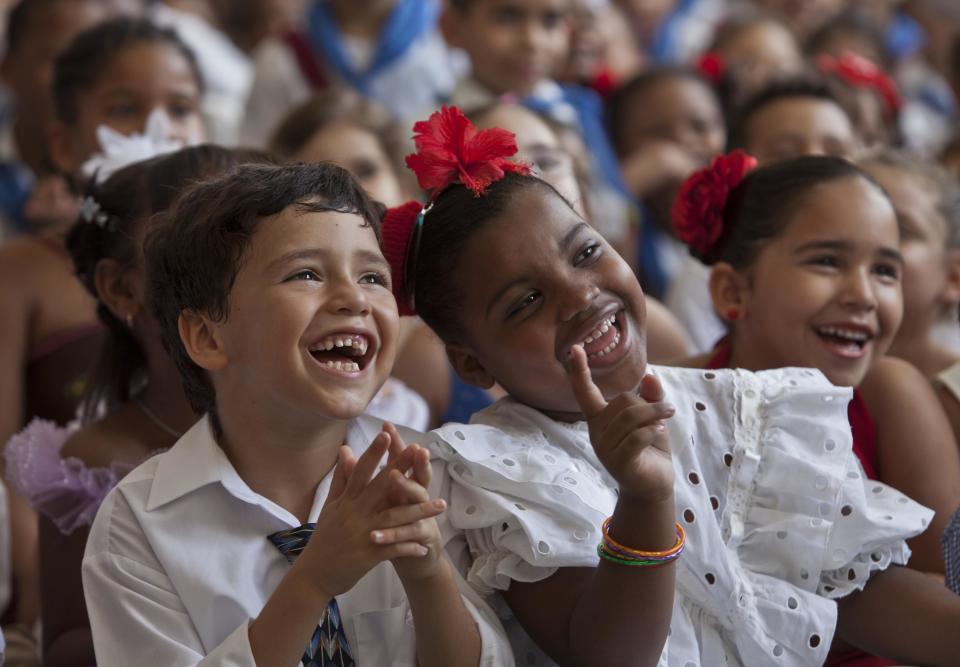 Schoolchildren laugh during a celebration to mark the anniversaries of the Organization of Cuban Pioneers and of the Union of Communist Youth at the Angela Landa elementary school in Old Havana, Cuba, Friday, April 4, 2014. Cuban school children are referred to as "pioneers," and the organization was founded in 1961 to encourage the values of education and social responsibility among children and adolescents. (AP Photo/Franklin Reyes)