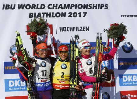 Biathlon - IBU World Championships - Women 12.5 km Mass Start - Hochfilzen, Austria - 19/2/17 - Susan Dunklee of the U.S., Laura Dahlmeier of Germany and Kaisa Makarainen of Finland on the podium. REUTERS/Leonhard Foeger