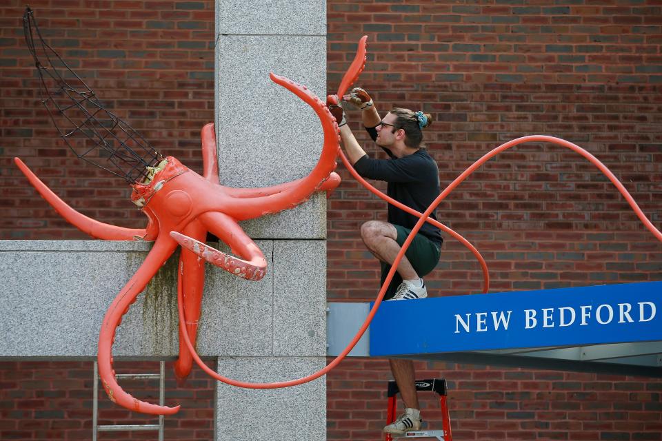 Enzo Cruz removes the iconic squid sculpture from the entrance of the Whaling Museum in New Bedford.  The weather had taken a toll on the sculpture by local artist Erik Durant and needed to be removed.
