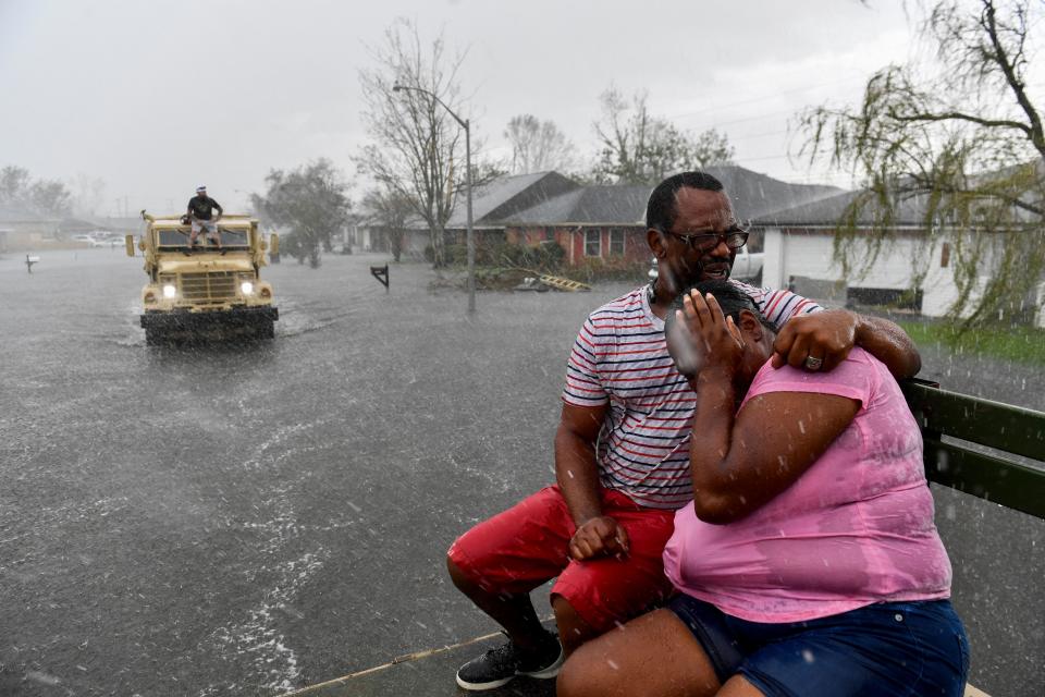 Just as more showers start, a high-water truck arrives to assist people evacuating from flooded homes in LaPlace, La., on Aug. 30, 2021.