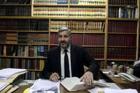 Leader of the Khatm-e-Nubuwwat Lawyers' Forum, a conservative alliance of lawyers offering free legal advice for anyone filing a blasphemy case, Ghulam Mustafa Chaudhry poses for a portrait at his office in Lahore, Pakistan February 22, 2016. REUTERS/Mohsin Raza