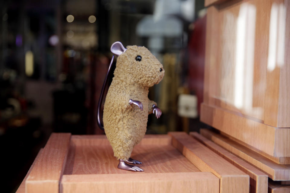 A rat figurine is displayed in a shop at Montenapoleone shopping district, in Milan, Italy, Tuesday, Feb. 4, 2020. China's virus outbreak is giving global business a chill. In Milan’s luxury Montenapoleone shopping district, dozens of luxury brands decked out their windows for Chinese New Year. But wealthy Chinese shoppers, who are responsible for about one-third of all luxury purchases globally, have failed to arrive in their usual numbers. (AP Photo/Luca Bruno)