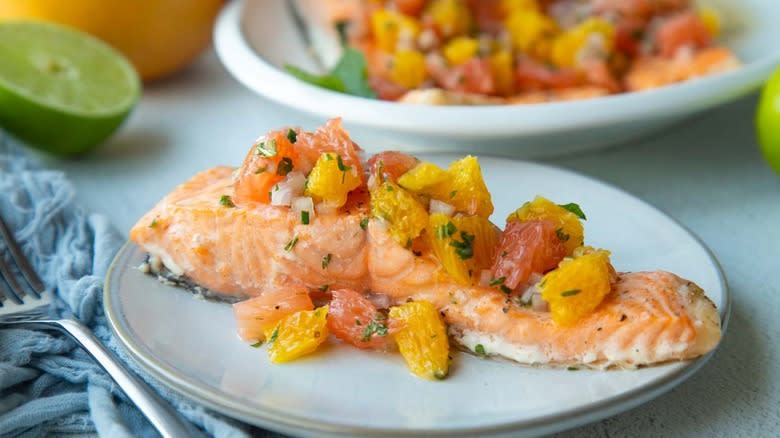 baked salmon with citrus salsa on white plate
