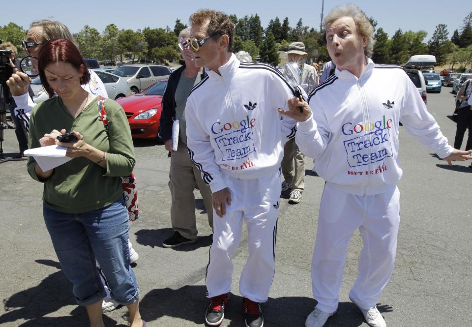 Consumer Watchdog demonstrator Derek Loughran, center, J. Schwartz, far left, and Don McLeod, right, protests in front of a Google shareholder outside of Google headquarters in Mountain View, Calif., Thursday, June 21, 2012 before the shareholders meeting. Protestors demonstrated to help raise awareness of Google's online tracking policy. They are calling for legislation for "Do Not Track" mechanism urged by the FTC. They are protesting information from being gathered by Google without permission. (AP Photo/Paul Sakuma)