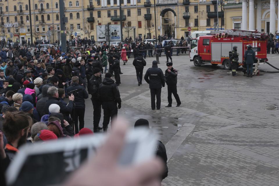 Russian police and emergency service officers block an area next to fire trucks at Sadovaya Square after explosion in St.Petersburg subway in St. Petersburg, Russia, Monday, April 3, 2017. The subway in the Russian city of St. Petersburg an explosion on a subway train. (AP Photo/Yevgeny Kurskov)