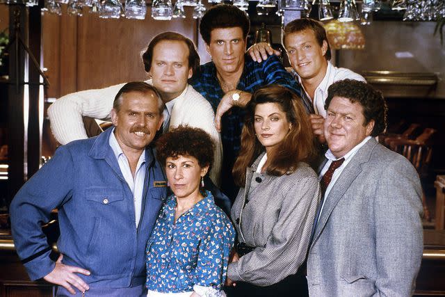 <p>NBCU Photo Bank/Getty</p> Kelsey Grammer, Ted Danson, Woody Harrelson, John Ratzenberger, Rhea Perlman, Kirstie Alley and George Wendt on 'Cheers'