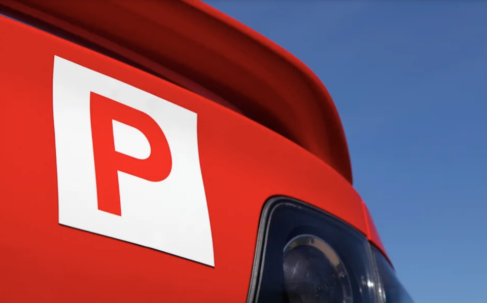 A car with red p-plates is pictured.