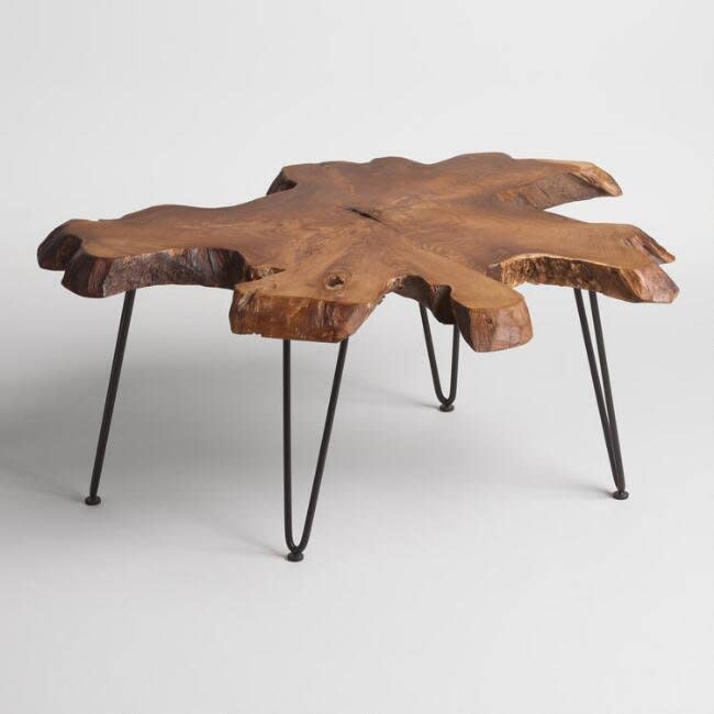 <a href="https://www.worldmarket.com/product/wood-slice-coffee-table.do?sortby=ourPicks&amp;from=fn" target="_blank">The variation in shape and design of this coffee table</a> will add more dimension to your space. It also acts as a standout piece,&nbsp;allowing you to keep your other pieces simple.