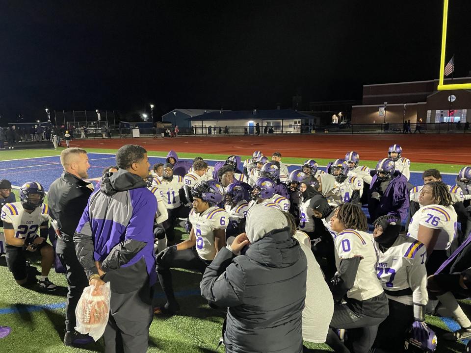 East/World of Inquiry co-coaches Steve Flagler and James Vann addresses their football team after winning a regionals for the first time since 1996.
