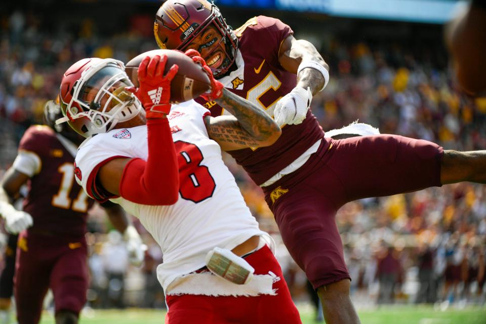 Miami-Ohio wide receiver Mac Hippenhammer (8) catches a 33-yard pass for a touchdown in front of Minnesota defensive back Coney Durr during the second half of an NCAA college football game on Saturday, Sept. 11, 2021, in Minneapolis. Minnesota won 31-26. (AP Photo/Craig Lassig)