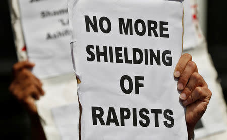 People hold placards at a protest against the rape of an eight-year-old girl, in Kathua, near Jammu and a teenager in Unnao, Uttar Pradesh state, in New Delhi, India April 12, 2018. REUTERS/Cathal McNaughton