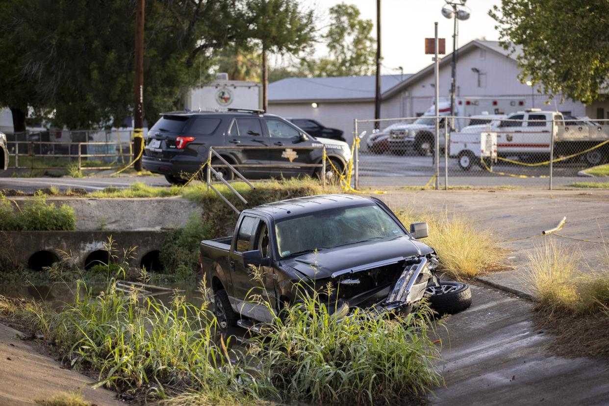 A truck reportedly driven by Salvador Ramos, the gunman who fatally shot 19 children and two adults on Tuesday, remains in the drainage ditch where it crashed near Robb Elementary School on Wednesday morning, May 25. 