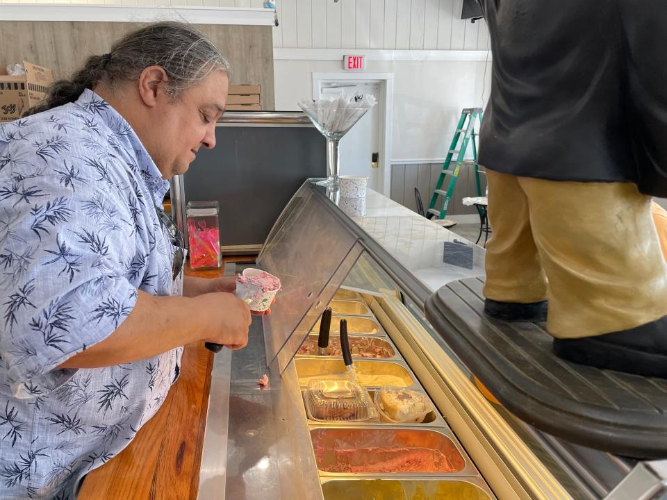 O.J. Molinaro, who opened Aunt G's Italian Kitchen in Fort Pierce, scoops gelato for a customer on July 25, 2023.