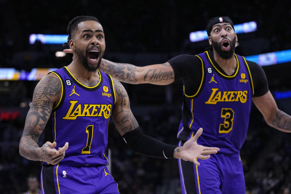 Los Angeles Lakers guard D'Angelo Russell (1) and forward Anthony Davis (3) react to a call during the second half of the team's NBA basketball game against the Minnesota Timberwolves, Friday, March 31, 2023, in Minneapolis. (AP Photo/Abbie Parr)