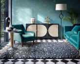 <p> If you can't decide between a green or blue living room  – choosing an Art Deco-inspired teal lounge with a marble checkered floor is a classy and elegant option. </p> <p> But, if you're scared that the space might look a tad on the dark side, choose a spot that's near the garden or place furniture near large windows. That way, you can layer natural sunlight with multiple living room lighting ideas to balance out light and dark. </p> <p> The addition of metallic surfaces such as the brass table and candlestick holder on the black and rattan cabinet will help to reflect light. </p>