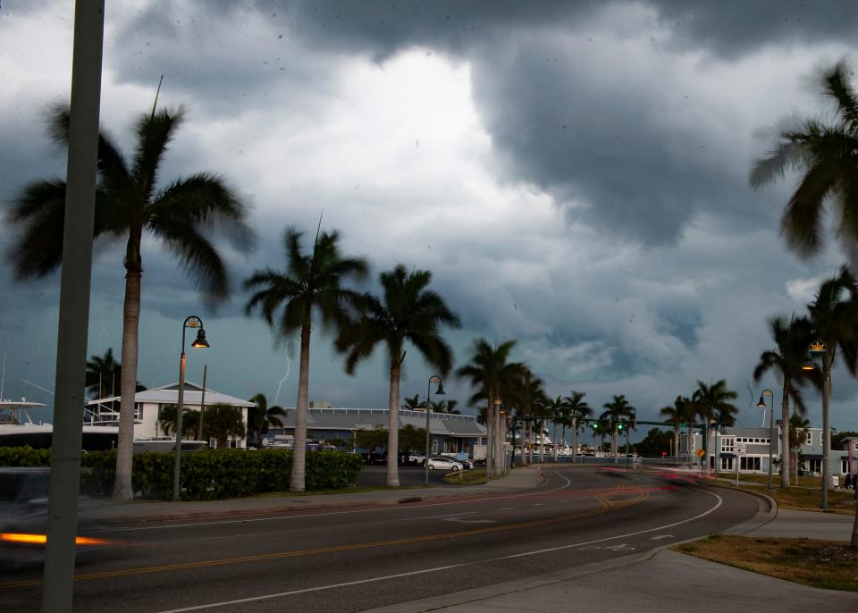 Palm tree branches sway in the wind as a weather front approaches along Seaway Drive by Pelican Yacht Club on Wednesday, May 15, 2024, in Fort Pierce.