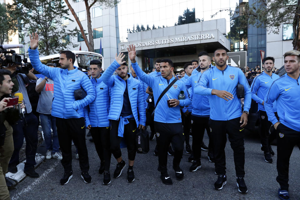 Boca Juniors players wave to supporters outside the team hotel in Madrid Saturday, Dec. 8, 2018. The Copa Libertadores Final between River Plate and Boca Juniors will be played on Dec. 9 in Madrid, Spain, at Real Madrid's stadium. (AP Photo/Manu Fernandez)