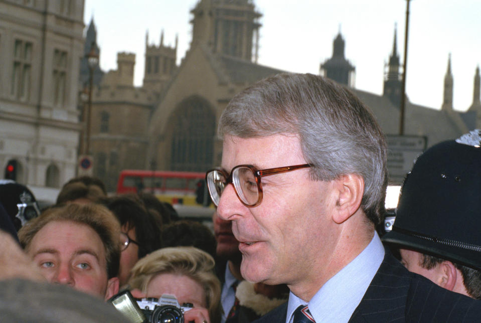 FILE - In this Thursday, Nov. 22, 1990, file photo, Britain's then Treasury chief John Major outside Parliament after he announced he would stand to replace Margaret Thatcher as prime minister. He won and sought to mend fences with the then European Community while still negotiating an opt-out to keep Britain out of the euro single currency. On Jan. 31, 2020, Britain is scheduled to leave what became known as the European Union after 47 years of membership. (AP Photo/Robin Nowacki, File)