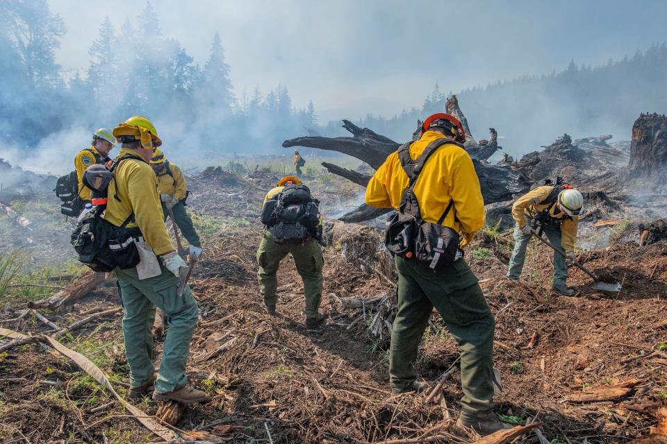 Wildland firefighters complete their week-long training at the Mid-Willamette Valley Interagency Wildland Fire School by putting out burn piles on June 28.
